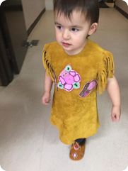 traditional First Nation dress with bead work and fringes